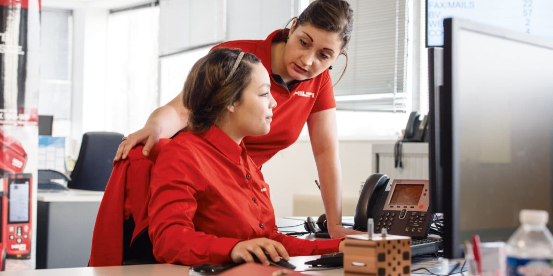 Hilti customer service representatives at the computer