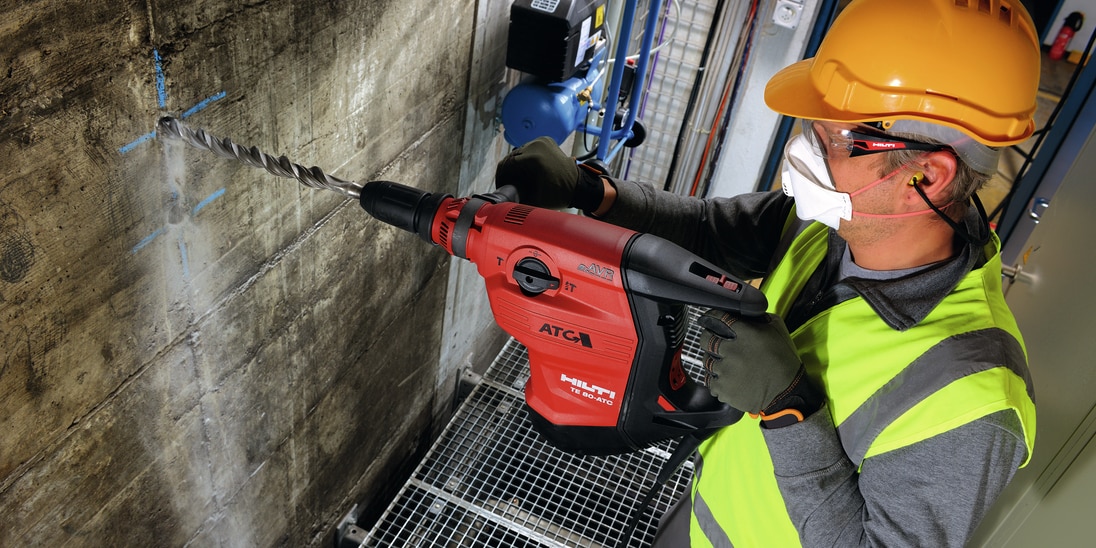 Construction worker using a TE 80-ATC/AVR Corded combihammer  with Active Torque Control (ATC) to help prevent kickback