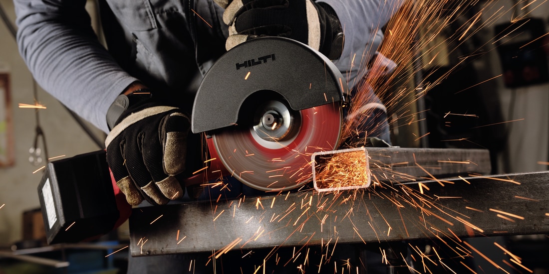 Construction worker using a AG 600-A36 Cordless angle grinder with Active Torque Control (ATC) to help prevent kickback