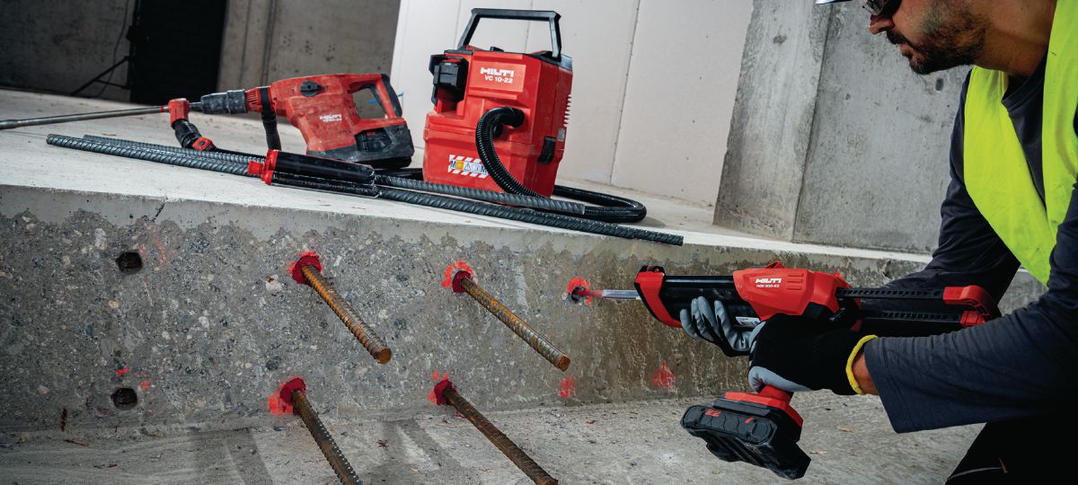 Jobsite   worker injecting    RE 500 with cordless dispenser HDE 500-22 into concrete for rebar  installation