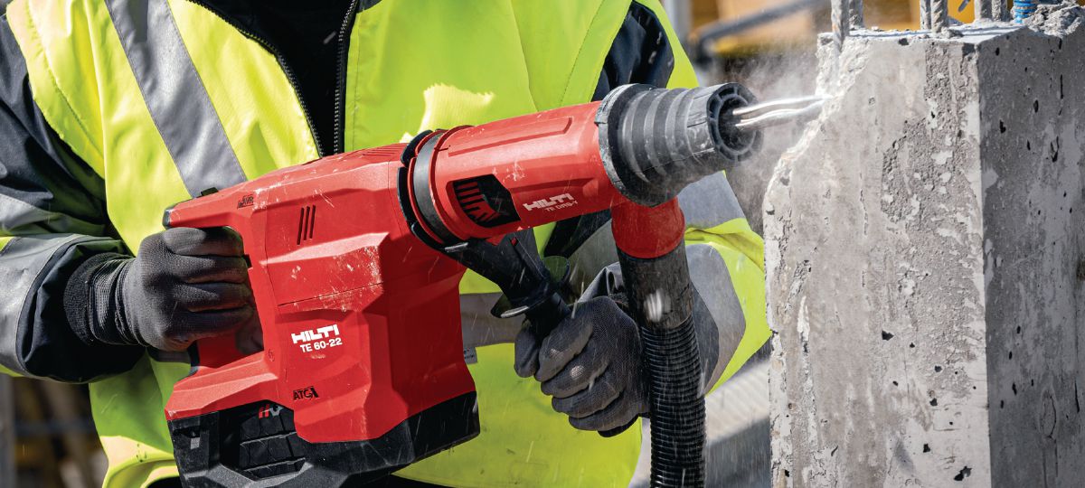 Breaking concrete with powerful SDS-Max combihammer TE 60-22 with pointed chisel and DRS-Y.