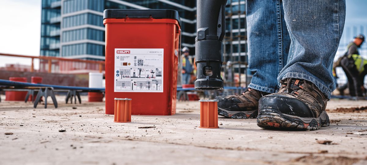 Cropped application image of Construction worker installing KCCM WF anchor onto wood formwork using the Kwik Cast setting tool. KCM-WF-ST. Dallas, TX. 2024.