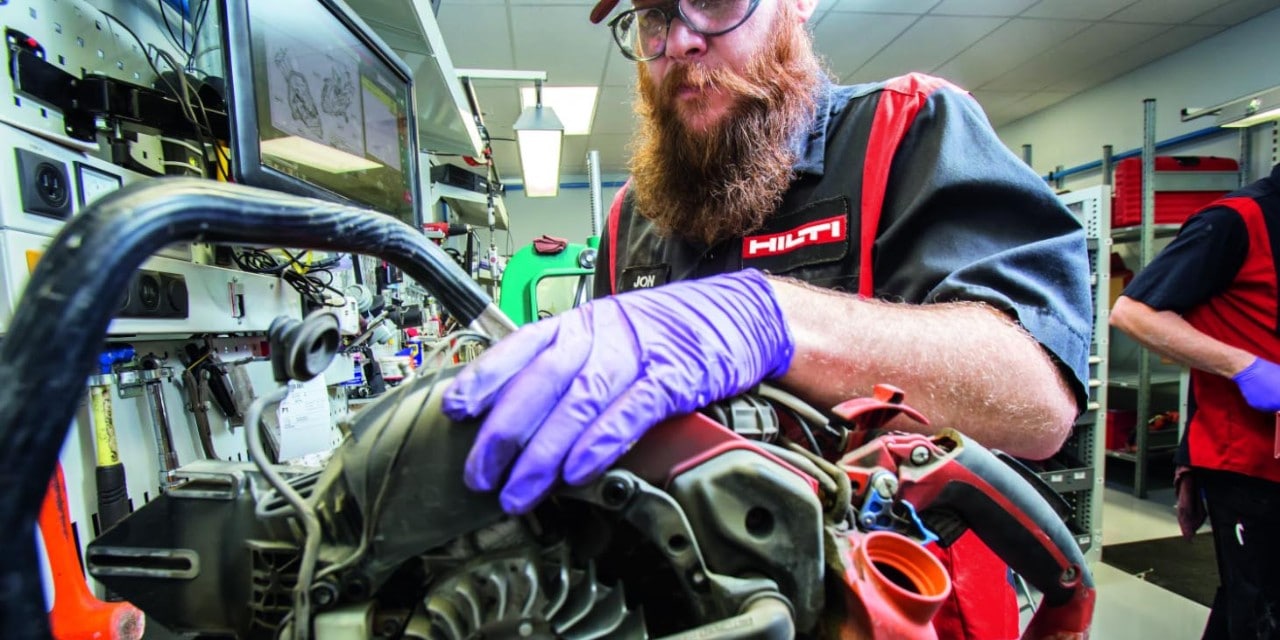 A technician works on a gas saw in a Hilti repair center